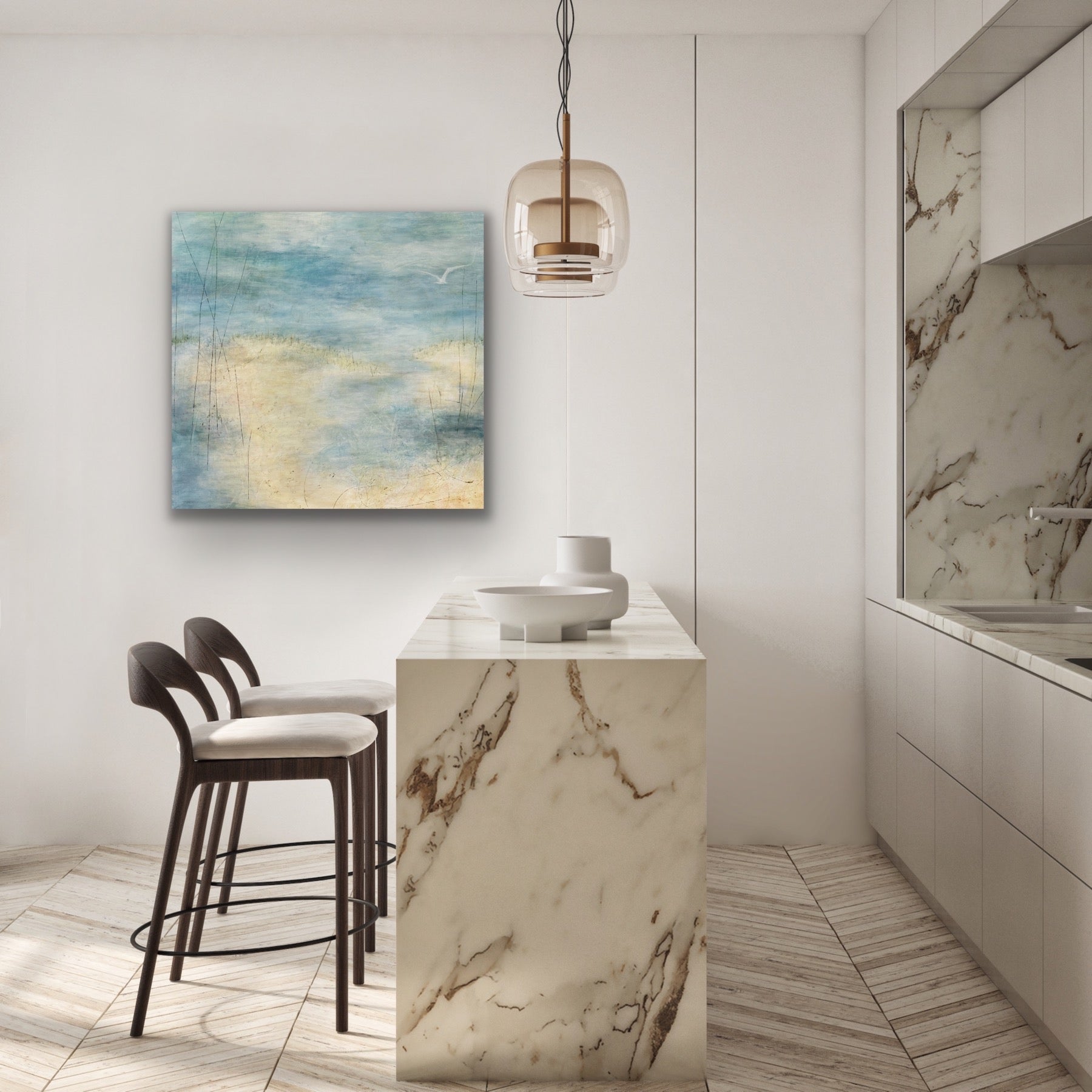 Insitu white marble bar and sink, white walls and an acrylic painting of a soft seascape with water overlapping sand in some areas. There is one lone seagull flying over the water. Painting by Juanita Bellavance, Cumming, GA artist